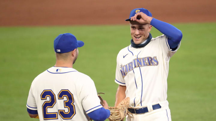 Evan White chats with Ty France on the field in between innings.