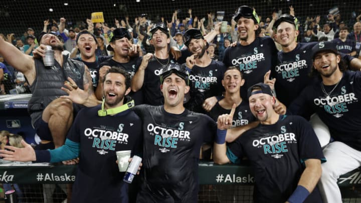 SEATTLE, WASHINGTON - SEPTEMBER 30: Members of the Seattle Mariners celebrate after clinching a postseason birth after beating the Oakland Athletics 2-1 at T-Mobile Park on September 30, 2022 in Seattle, Washington. The Seattle Mariners have clinched a postseason appearance for the first time in 21 years, the longest playoff drought in North American professional sports. (Photo by Steph Chambers/Getty Images)