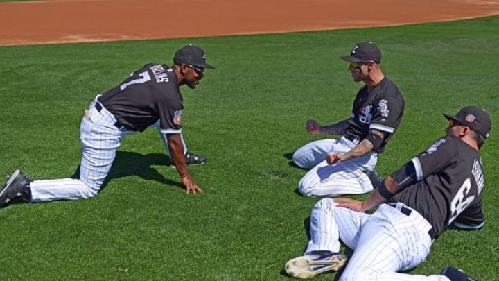 Mar 18, 2016; Phoenix, AZ, USA; Chicago White Sox shortstop Jimmy Rollins (7), third baseman Brett Lawrie (15) and first baseman Travis Ishikawa (64) stretch before the game against the Chicago Cubs at Camelback Ranch. Mandatory Credit: Jake Roth-USA TODAY Sports