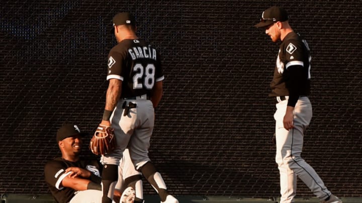 KANSAS CITY, MISSOURI - JULY 16: Right fielder Eloy Jimenez #74 of the Chicago White Sox rest up against the wall as he is looked upon by teammates Leury Garcia #28 and Charlie Tilson #22 in the first inning at Kauffman Stadium on July 16, 2019 in Kansas City, Missouri. Jimenez was injured and left the game after colliding into Tilson while trying to catch a ball hit by Whit Merrifield of the Kansas City Royals. (Photo by Ed Zurga/Getty Images)