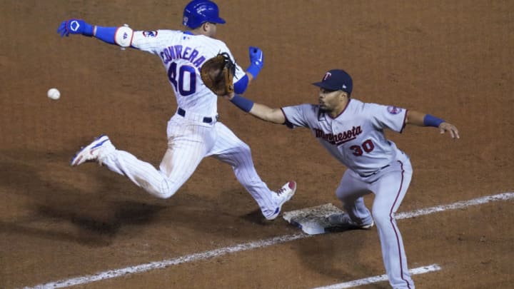 CHICAGO, ILLINOIS - SEPTEMBER 20: Willson Contreras #40 of the Chicago Cubs is safe at first base while LaMonte Wade Jr. #30 of the Minnesota Twins waits for the throw during the ninth inning of a game at Wrigley Field on September 20, 2020 in Chicago, Illinois. (Photo by Nuccio DiNuzzo/Getty Images)