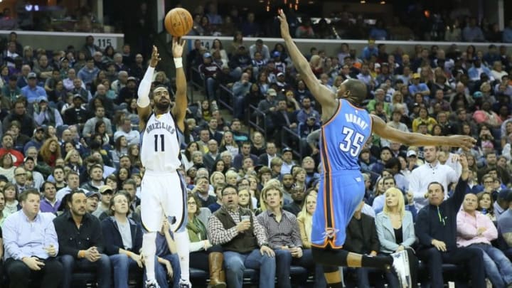 Jan 31, 2015; Memphis, TN, USA; Memphis Grizzlies guard Mike Conley (11) attempts a shot during the second quarter defended by Oklahoma City Thunder forward Kevin Durant (35) at FedExForum. Mandatory Credit: Nelson Chenault-USA TODAY Sports