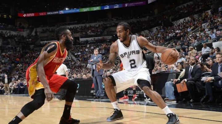 SAN ANTONIO, TX - APRIL 8: Kawhi Leonard #2 of the San Antonio Spurs handles the ball against James Harden #13 of the Houston Rockets on April 8, 2015 at the AT&T Center in San Antonio, Texas. NOTE TO USER: User expressly acknowledges and agrees that, by downloading and or using this photograph, user is consenting to the terms and conditions of the Getty Images License Agreement. Mandatory Copyright Notice: Copyright 2015 NBAE (Photos by D. Clarke Evans/NBAE via Getty Images)