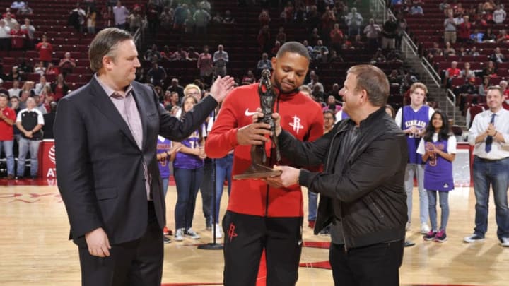 HOUSTON, TX - OCTOBER 23: The Houston Rockets new owner Tilman Fertitta and GM Daryl Morey present Eric Gordon #10 of the Houston Rockets with the 6th Man of the Year Award before the game against the Memphis Grizzlies on October 23, 2017 at the Toyota Center in Houston, Texas. NOTE TO USER: User expressly acknowledges and agrees that, by downloading and or using this photograph, User is consenting to the terms and conditions of the Getty Images License Agreement. Mandatory Copyright Notice: Copyright 2017 NBAE (Photo by Bill Baptist/NBAE via Getty Images)