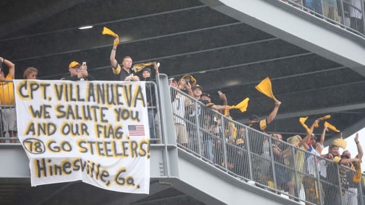 Sep 18, 2016; Pittsburgh, PA, USA; Pittsburgh Steelers fans cheer near a sign for tackle Alejandro Villanueva (not pictured) against the Cincinnati Bengals during the fourth quarter at Heinz Field. The Pittsburgh Steelers won 24-16. Mandatory Credit: Charles LeClaire-USA TODAY Sports