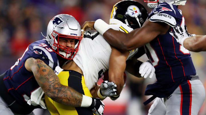 FOXBOROUGH, MASSACHUSETTS - SEPTEMBER 08: Lawrence Guy #93 of the New England Patriots tackles James Conner #30 of the Pittsburgh Steelers during the game between the New England Patriots and the Pittsburgh Steelers at Gillette Stadium on September 08, 2019 in Foxborough, Massachusetts. (Photo by Maddie Meyer/Getty Images)