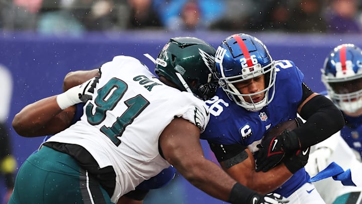 Fletcher Cox #91 of the Philadelphia Eagles tackles Saquon Barkley #26 of the New York Giants. (Photo by Al Bello/Getty Images)