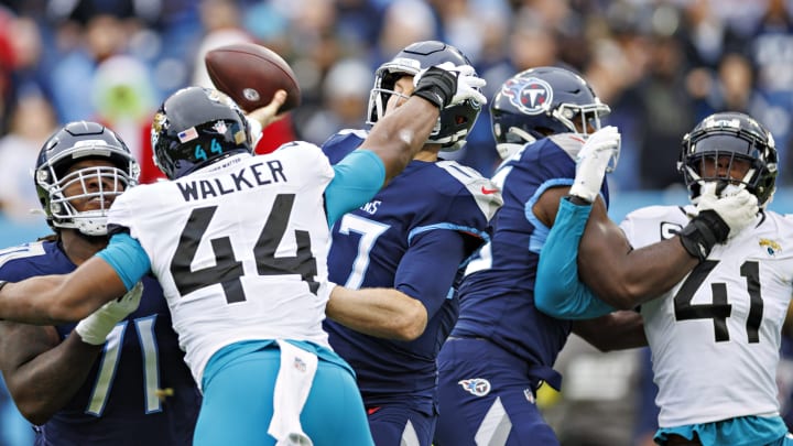 Ryan Tannehill #16 of the Tennessee Titans is hit while throwing a pass by Travon Walker #44 of the Jacksonville Jaguars. (Photo by Wesley Hitt/Getty Images)
