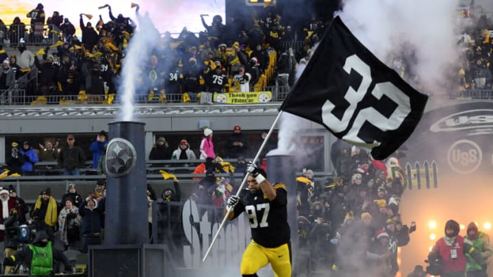PITTSBURGH, PENNSYLVANIA - DECEMBER 24: Cameron Heyward #97 of the Pittsburgh Steelers runs on to the field holdinga #32 flag to honor Franco Harris during the game against the Las Vegas Raiders at Acrisure Stadium on December 24, 2022 in Pittsburgh, Pennsylvania. (Photo by Justin Berl/Getty Images)