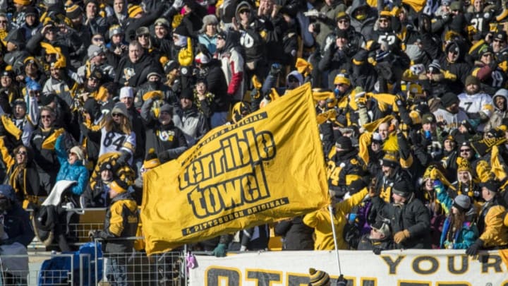 PITTSBURGH, PA - JANUARY 14: Pittsburgh Steelers fans cheer as a stadium staff member waves a Terrible Towel flag during the second quarter against the Jacksonville Jaguars in the AFC Divisional Playoff game at Heinz Field on January 14, 2018 in Pittsburgh, Pennsylvania. Jaguars defeat Pittsburgh 45-42. (Photo by Brett Carlsen/Getty Images) *** Local Caption ***