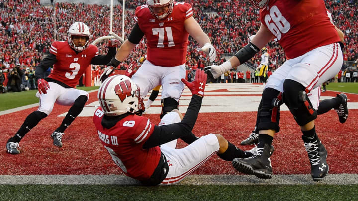 MADISON, WISCONSIN – NOVEMBER 09: Danny Davis III #6 of the Wisconsin Badgers celebrates with Kendric Pryor #3, Cole Van Lanen #71 and David Moorman #68 of the Wisconsin Badgers after scoring a touchdown in the first half against the Iowa Hawkeyes at Camp Randall Stadium on November 09, 2019 in Madison, Wisconsin. (Photo by Quinn Harris/Getty Images)