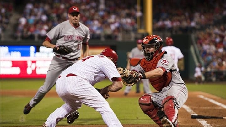 Aug 21, 2012; Philadelphia, PA, USA; Philadelphia Phillies pinch hitter Ty Wigginton (24) is tagged out by Cincinnati Reds catcher Ryan Hanigan (29) during the seventh inning at Citizens Bank Park. The Reds defeated the Phillies 5-4. Mandatory Credit: Howard Smith-US PRESSWIRE