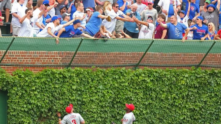 May 28, 2016; Chicago, IL, USA; Philadelphia Phillies left fielder David Lough (3) and center fielder Odubel Herrera (37) watch fans catch a home run off the bat of Chicago Cubs center fielder Dexter Fowler (not pictured) during the first inning at Wrigley Field. Mandatory Credit: Dennis Wierzbicki-USA TODAY Sports