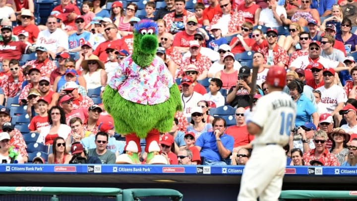 Jun 19, 2016; Philadelphia, PA, USA; The Phillie Phanatic watches as Philadelphia Phillies second baseman Cesar Hernandez (16) heads back to the dugout after striking out against the Arizona Diamondbacks at Citizens Bank Park. The Diamondbacks defeated the Phillies, 5-1. Mandatory Credit: Eric Hartline-USA TODAY Sports