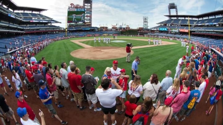 Jul 16, 2016; Philadelphia, PA, USA; Fans line the playing field at Citizens Bank Park for the Philadelphia Phillies picture day with the players prior to game against the New York Mets. Mandatory Credit: Bill Streicher-USA TODAY Sports