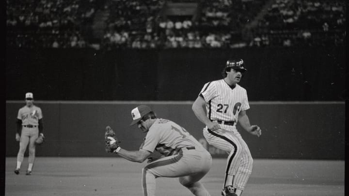 (Original Caption) Expos Pete Rose keeps Phillies’ Glenn Wilson close to first base on a pickoff attempt in the sixth inning, July 27th. Rose tied and broke Ty Cobb’s record for singles with two hits. The record is 3053 singles.