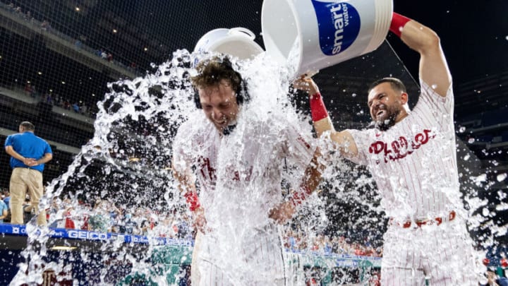 Jun 13, 2022; Philadelphia, Pennsylvania, USA; Philadelphia Phillies first baseman Rhys Hoskins (17) is doused with water by left fielder Kyle Schwarber (12) after hitting a game winning walk off double during the ninth inning against the Miami Marlins at Citizens Bank Park. Mandatory Credit: Bill Streicher-USA TODAY Sports