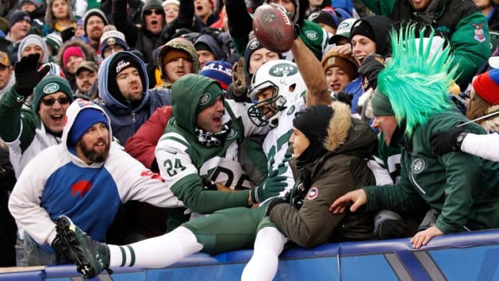 Jan 3, 2016; Orchard Park, NY, USA; New York Jets fans surround New York Jets wide receiver Eric Decker (87) after he scored a touchdown against the Buffalo Bills at Ralph Wilson Stadium. Mandatory Credit: Kevin Hoffman-USA TODAY Sports