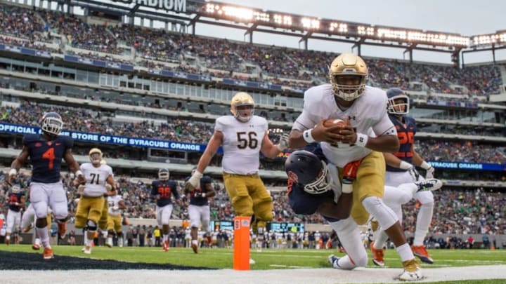 Oct 1, 2016; East Rutherford, NJ, USA; Notre Dame Fighting Irish quarterback DeShone Kizer (14) is tackled by Syracuse Orange cornerback Corey Winfield (11) in the first quarter at MetLife Stadium. Mandatory Credit: Matt Cashore-USA TODAY Sports