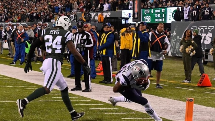 Nov 27, 2016; East Rutherford, NJ, USA; New England Patriots wide receiver Malcolm Mitchell (19) scores the game winning touchdown in front of New York Jets cornerback Darrelle Revis (24) during the second half at MetLife Stadium. Mandatory Credit: Robert Deutsch-USA TODAY Sports