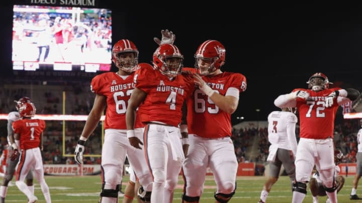 HOUSTON, TX - NOVEMBER 10: D'Eriq King #4 of the Houston Cougars is congratulated by Will Noble #69 and Jarrid Williams #62 after a touchdown in the third quarter against the Temple Owls at TDECU Stadium on November 10, 2018 in Houston, Texas. (Photo by Tim Warner/Getty Images)