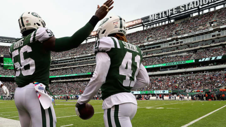 EAST RUTHERFORD, NJ - OCTOBER 15: Cornerback Buster Skrine #41 of the New York Jets celebrates his interception with teammate inside linebacker Demario Davis #56 against the New England Patriots during the second quarter of their game at MetLife Stadium on October 15, 2017 in East Rutherford, New Jersey. (Photo by Al Bello/Getty Images)