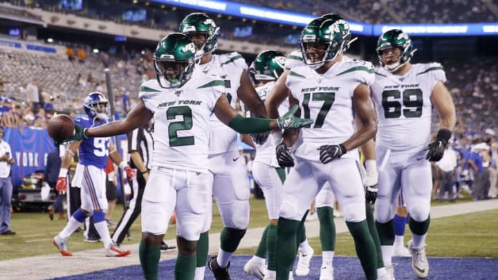 EAST RUTHERFORD, NEW JERSEY - AUGUST 08: Greg Dortch #2 of the New York Jets celebrates his touchdown with teammates Charone Peake #17 and Ben Braden #69 in the fourth quarter against the New York Giants during a preseason matchup at MetLife Stadium on August 08, 2019 in East Rutherford, New Jersey. (Photo by Elsa/Getty Images)