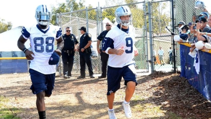 Jul 30, 2015; Oxnard, CA, USA; Dallas Cowboys quarterback Tony Romo (9) and wide receiver Dez Bryant (88) run on to the field for the first day of training camp at River Ridge Fields. Mandatory Credit: Jayne Kamin-Oncea-USA TODAY Sports