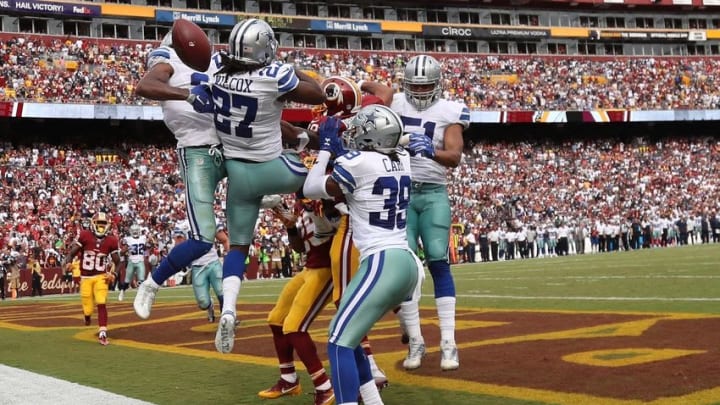 Sep 18, 2016; Landover, MD, USA; Dallas Cowboys safety Byron Jones (31) and Cowboys safety J.J. Wilcox (27) bat down a hail-mary pass attempt intended for Washington Redskins wide receiver Josh Doctson (18) on the final play of the game in the fourth quarter at FedEx Field. The Cowboys won 27-23. Mandatory Credit: Geoff Burke-USA TODAY Sports