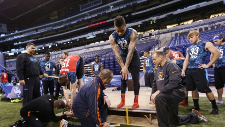 INDIANAPOLIS, IN - FEBRUARY 24: Coaches are seen measuring wide receivers during the 2013 NFL Combine at Lucas Oil Stadium on February 24, 2013 in Indianapolis, Indiana. (Photo by Joe Robbins/Getty Images)