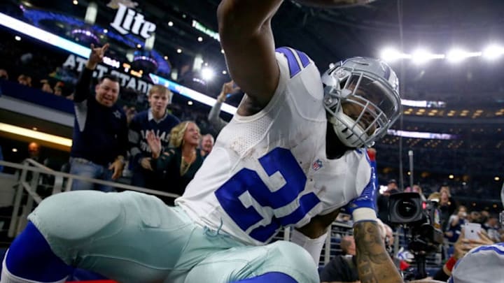 ARLINGTON, TX - DECEMBER 18: Ezekiel Elliott #21 of the Dallas Cowboys celebrates after scoring a touchdown by jumping into a Salvation Army red kettle during the second quarter against the Tampa Bay Buccaneers at AT&T Stadium on December 18, 2016 in Arlington, Texas. (Photo by Tom Pennington/Getty Images) ARLINGTON, TX - DECEMBER 18: Ezekiel Elliott #21 of the Dallas Cowboys celebrates after scoring a touchdown by jumping into a Salvation Army red kettle during the second quarter against the Tampa Bay Buccaneers at AT&T Stadium on December 18, 2016 in Arlington, Texas. (Photo by Tom Pennington/Getty Images)
