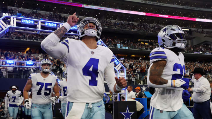 ARLINGTON, TEXAS - DECEMBER 24: Dak Prescott #4 of the Dallas Cowboys and Ezekiel Elliott #21 of the Dallas Cowboys run onto the field before the game against the Philadelphia Eagles at AT&T Stadium on December 24, 2022 in Arlington, Texas. (Photo by Richard Rodriguez/Getty Images)