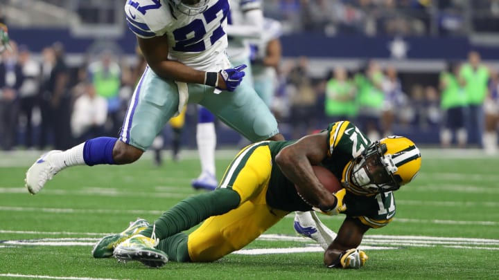 Jan 15, 2017; Arlington, TX, USA; Green Bay Packers wide receiver Davante Adams (17) is tackled by Dallas Cowboys strong safety J.J. Wilcox (27) during the second quarter in the NFC Divisional playoff game at AT&T Stadium. Mandatory Credit: Kevin Jairaj-USA TODAY Sports