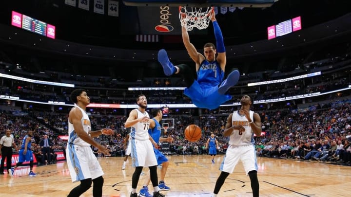Mar 28, 2016; Denver, CO, USA; Dallas Mavericks forward Dwight Powell (7) dunks the ball against Denver Nuggets guard Gary Harris (14) and center Joffrey Lauvergne (77) and guard JaKarr Sampson (9) in the fourth quarter at the Pepsi Center. The Mavericks defeated the Nuggets 97-88. Mandatory Credit: Isaiah J. Downing-USA TODAY Sports