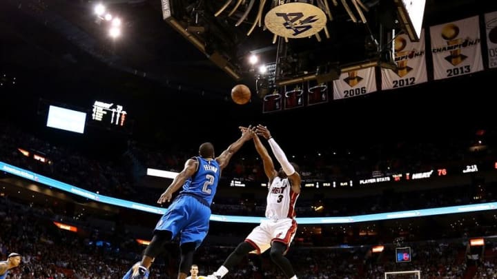 Jan 1, 2016; Miami, FL, USA; Miami Heat guard Dwyane Wade (3) shoots over Dallas Mavericks guard Raymond Felton (2) during the second half at American Airlines Arena. Mandatory Credit: Steve Mitchell-USA TODAY Sports