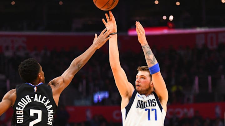 LOS ANGELES, CA - FEBRUARY 25: Dallas Mavericks Guard Luka Doncic (77) shoots over Los Angeles Clippers Guard Shai Gilgeous-Alexander (2) during a NBA game between the Dallas Mavericks and the Los Angeles Clippers on February 25, 2019 at STAPLES Center in Los Angeles, CA. (Photo by Brian Rothmuller/Icon Sportswire via Getty Images)