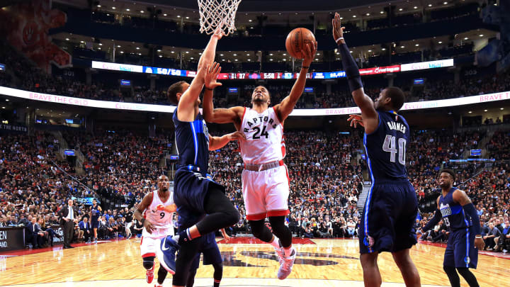 TORONTO, ON – MARCH 13: Norman Powell #24 of the Toronto Raptors shoots the ball as Dwight Powell #7 and Harrison Barnes #40 of the Dallas Mavericks defend during the first half of an NBA game at Air Canada Centre on March 13, 2017 in Toronto, Canada. NOTE TO USER: User expressly acknowledges and agrees that, by downloading and or using this photograph, User is consenting to the terms and conditions of the Getty Images License Agreement. (Photo by Vaughn Ridley/Getty Images)
