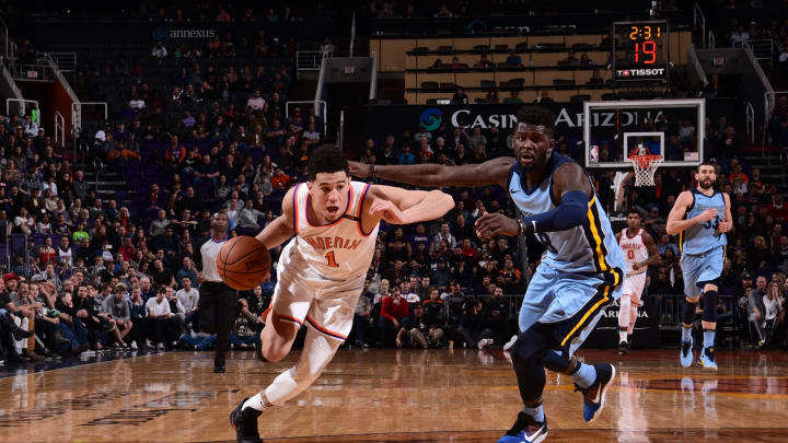 PHOENIX, AZ -DECEMBER 26: Devin Booker #1 of the Phoenix Suns handles the ball against James Ennis III #8 of the Memphis Grizzlies on December 26, 2017 at Talking Stick Resort Arena in Phoenix, Arizona. NOTE TO USER: User expressly acknowledges and agrees that, by downloading and or using this photograph, user is consenting to the terms and conditions of the Getty Images License Agreement. Mandatory Copyright Notice: Copyright 2017 NBAE (Photo by Michael Gonzales/NBAE via Getty Images)
