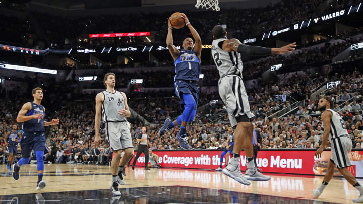 SAN ANTONIO,TX – NOVEMBER 27: Dennis Smith Jr. #1 of the Dallas Mavericks flies for two against LaMarcus Aldridge #12 of the San Antonio Spurs at AT&T Center on November 27, 2017 in San Antonio, Texas. NOTE TO USER: User expressly acknowledges and agrees that , by downloading and or using this photograph, User is consenting to the terms and conditions of the Getty Images License Agreement. (Photo by Ronald Cortes/Getty Images)