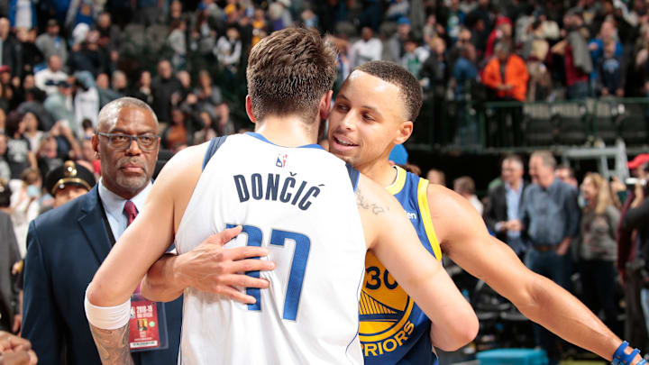 DALLAS, TX – JANUARY 13: Luka Doncic #77 of the Dallas Mavericks and Stephen Curry #30 of the Golden State Warriors hug after a game on January 13, 2019 at the American Airlines Center in Dallas, Texas. NOTE TO USER: User expressly acknowledges and agrees that, by downloading and or using this photograph, User is consenting to the terms and conditions of the Getty Images License Agreement. Mandatory Copyright Notice: Copyright 2019 NBAE (Photo by Glenn James/NBAE via Getty Images)