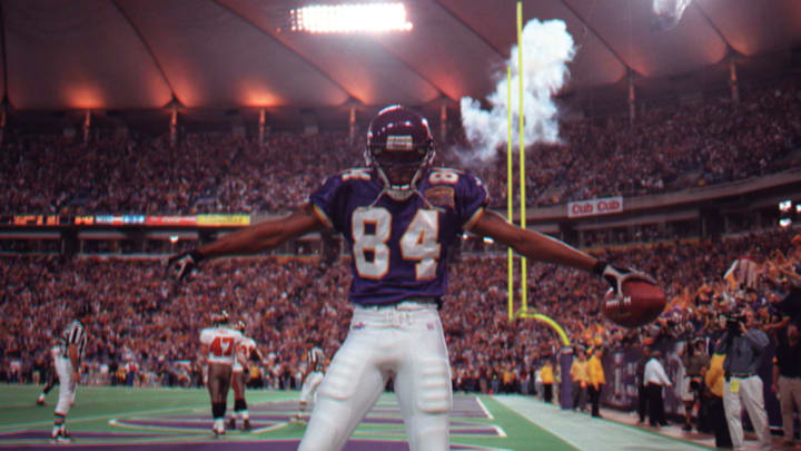 Randy Moss has a quiet moment before jumping into the estatic crowd to celebrate this fourth-quarter touchdown placing the Vikings in the lead 27-23. He caught a 45-yard pass from Daunte Culpepper.(Photo By JERRY HOLT/Star Tribune via Getty Images)