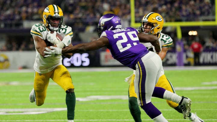 Aaron Jones with Xavier Rhodes #29 of the Minnesota Vikings (Photo by Adam Bettcher/Getty Images)