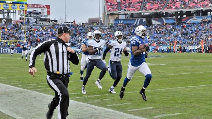 Dec 28, 2014; Nashville, TN, USA; Indianapolis Colts wide receiver Reggie Wayne (87) catches a pass and rushes to the ne yard line against Tennessee Titans cornerback Jason McCourty (30) and Tennessee cornerback Coty Sensabaugh (24) during the first half at LP Field. Mandatory Credit: Jim Brown-USA TODAY Sports