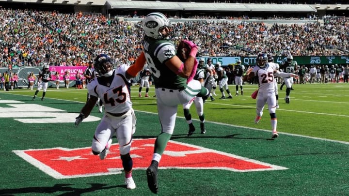 Oct 12, 2014; East Rutherford, NJ, USA; New York Jets tight end Jace Amaro (88) scores a touchdown defended by Denver Broncos strong safety T.J. Ward (43) during the first half at MetLife Stadium. Mandatory Credit: Robert Deutsch-USA TODAY Sports