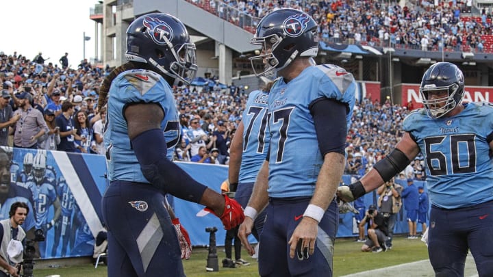 NASHVILLE, TENNESSEE – OCTOBER 20: Derrick Henry #22 of the Tennessee Titans is congratulated by teammate Ryan Tannehill #17 after scoring a touchdown against the Los Angeles Chargers during the second half at Nissan Stadium on October 20, 2019 in Nashville, Tennessee. (Photo by Frederick Breedon/Getty Images)