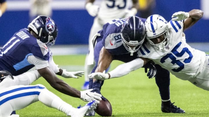 INDIANAPOLIS, IN - DECEMBER 01: A.J. Brown #11, Jonnu Smith #81 of the Tennessee Titans and Pierre Desir #35 of the Indianapolis Colts battle for a fumble in the fourth quarter of the game at Lucas Oil Stadium on December 1, 2019 in Indianapolis, Indiana. (Photo by Bobby Ellis/Getty Images)