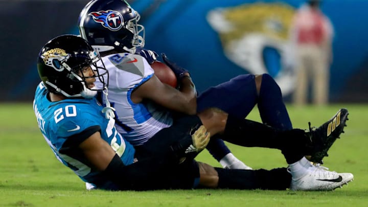 JACKSONVILLE, FLORIDA - SEPTEMBER 19: Jalen Ramsey #20 of the Jacksonville Jaguars tackles Corey Davis #84 of the Tennessee Titans during a game at TIAA Bank Field on September 19, 2019 in Jacksonville, Florida. (Photo by Mike Ehrmann/Getty Images)