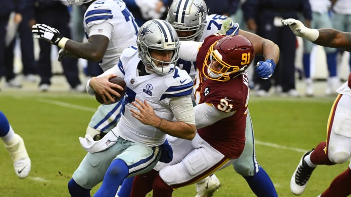 Oct 25, 2020; Landover, Maryland, USA; Washington Football Team defensive end Ryan Kerrigan (91) sacks Dallas Cowboys quarterback Ben DiNucci (7) during the second half at FedExField. Mandatory Credit: Brad Mills-USA TODAY Sports