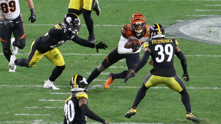 Nov 15, 2020; Pittsburgh, Pennsylvania, USA; Cincinnati Bengals wide receiver Tee Higgins (85) runs after a catch as Pittsburgh Steelers safety Antoine Brooks Jr. (25) and free safety Minkah Fitzpatrick (39) defend during the second quarter at Heinz Field. Mandatory Credit: Charles LeClaire-USA TODAY Sports