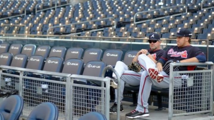 Aug 1, 2014; San Diego, CA, USA; Atlanta Braves starting pitcher Aaron Harang (right) and Atlanta Braves pitching coach Roger McDowell sit in the stands before a game against the San Diego Padres at Petco Park. Mandatory Credit: Jake Roth-USA TODAY Sports
